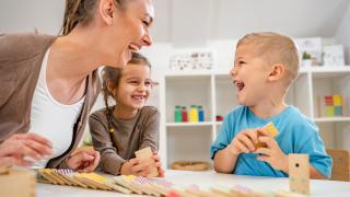 students and teacher laughing